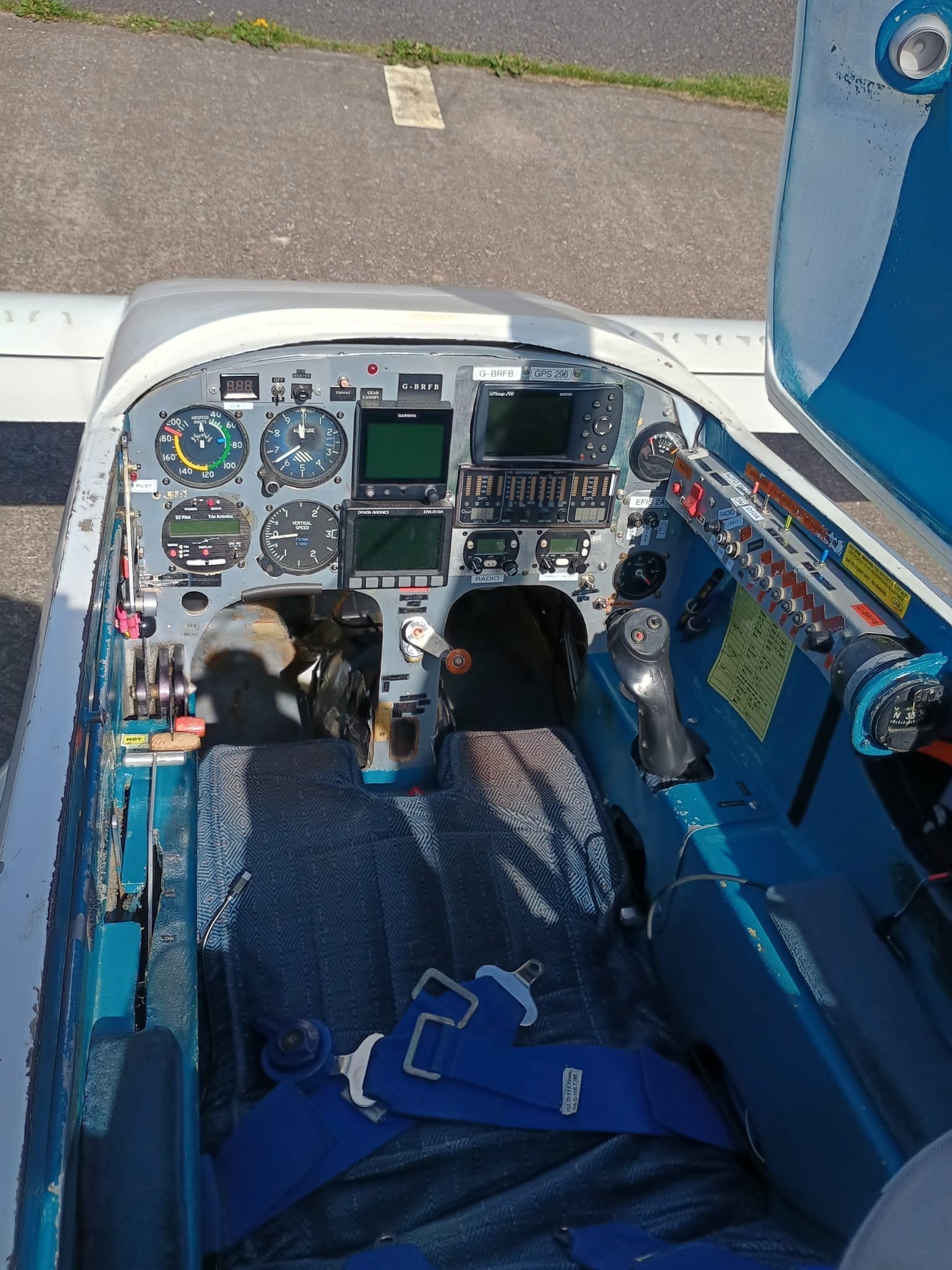 A photograph of the panel for G-BRFB, showing the aircraft instruments, including a Garmin G5, a Dynon D10, a GPSmap 296, and Trig radio and transponder.